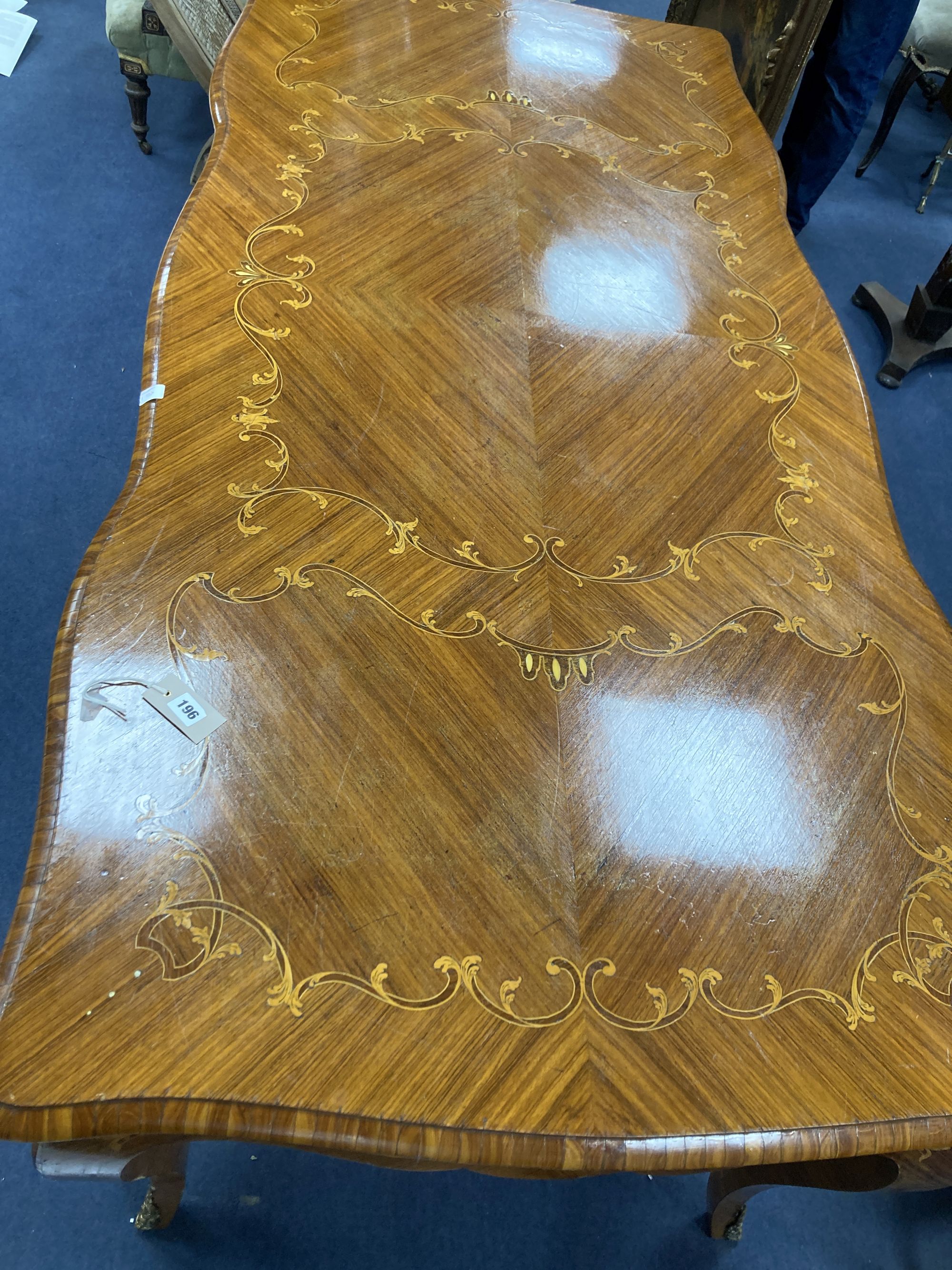 A Louis XVI design marquetry inlaid kingwood serpentine centre table, width 196cm depth 90cm height 79cm